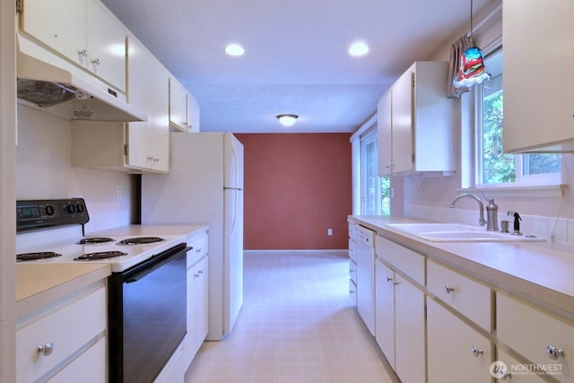 5211 53rd St W, University Place, WA 98467 - kitchen with electric range, under cabinet range hood, light countertops, light flooring, and recessed lighting
