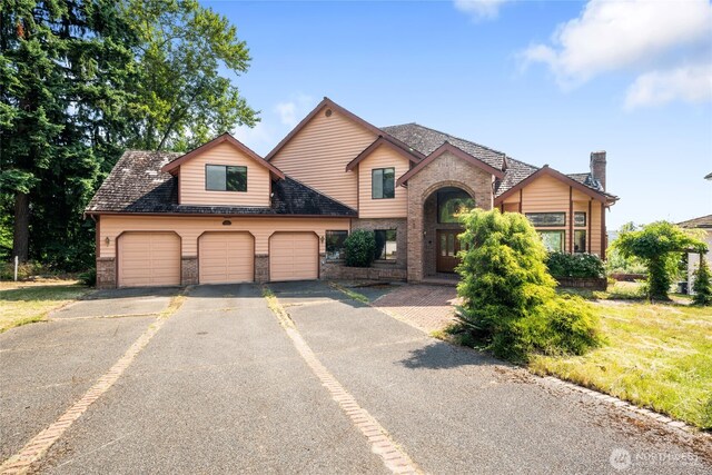 1408 W St NW, Auburn, WA 98001 - view of front of property with brick siding, asphalt driveway, and a garage