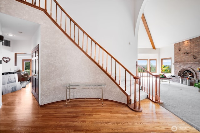 1408 W St NW, Auburn, WA 98001 - stairway featuring a high ceiling, wood finished floors, and a fireplace