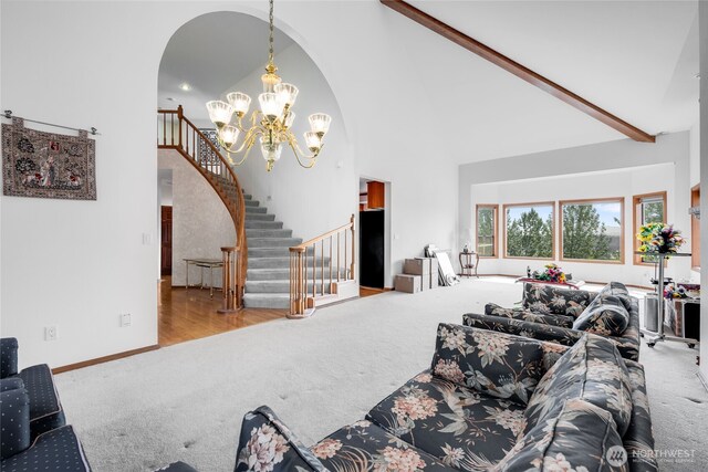 1408 W St NW, Auburn, WA 98001 - living area with carpet, high vaulted ceiling, a chandelier, arched walkways, and stairs