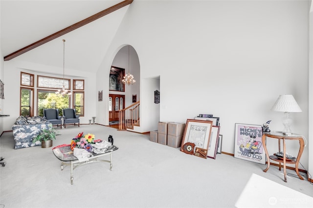 1408 W St NW, Auburn, WA 98001 - living area featuring carpet, high vaulted ceiling, a chandelier, arched walkways, and stairs
