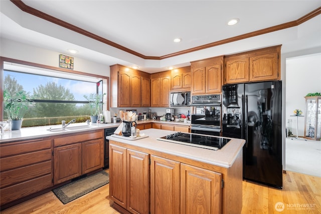 1408 W St NW, Auburn, WA 98001 - kitchen featuring black appliances, brown cabinetry, light countertops, light wood-type flooring, and recessed lighting