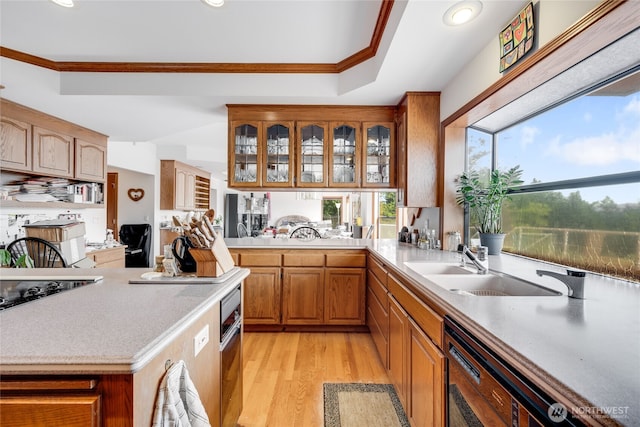 1408 W St NW, Auburn, WA 98001 - kitchen featuring healthy amount of natural light, light countertops, black appliances, light wood-style flooring, and ornamental molding