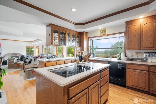 1408 W St NW, Auburn, WA 98001 - kitchen featuring black appliances, a raised ceiling, light countertops, brown cabinetry, and recessed lighting