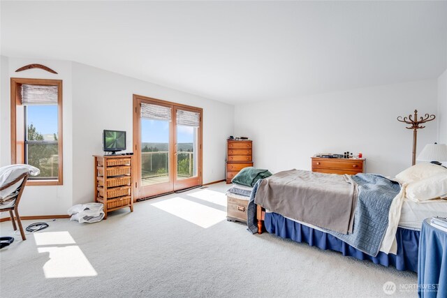 1408 W St NW, Auburn, WA 98001 - carpeted bedroom featuring access to exterior and multiple windows