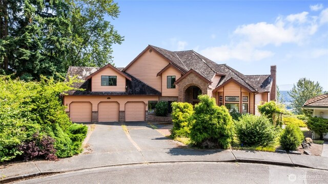 1408 W St NW, Auburn, WA 98001 - view of front of home featuring brick siding, driveway, and an attached garage