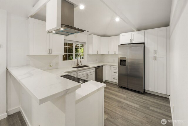 1140 E Seattle St, Kent, WA 98030 - kitchen with appliances with stainless steel finishes, island exhaust hood, light wood-style flooring, a peninsula, and white cabinets