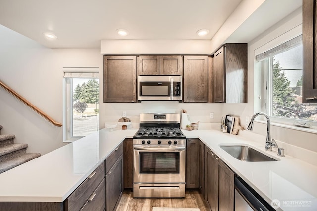 1823 SW 96th Ln, Seattle, WA 98106 - kitchen featuring stainless steel appliances, light countertops, dark brown cabinetry, plenty of natural light, and recessed lighting