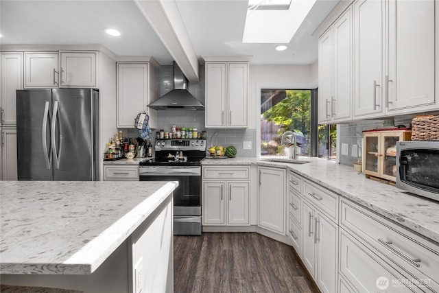 7818 185th Pl SW, Edmonds, WA 98026 - kitchen featuring stainless steel appliances, wall chimney range hood, a skylight, backsplash, and dark wood-style floors