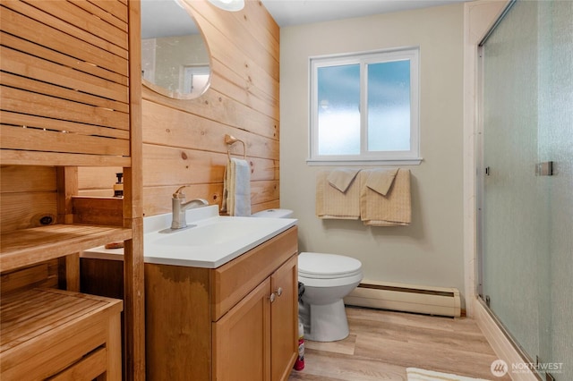 7818 185th Pl SW, Edmonds, WA 98026 - full bathroom featuring a baseboard heating unit, a stall shower, vanity, wood finished floors, and wooden walls
