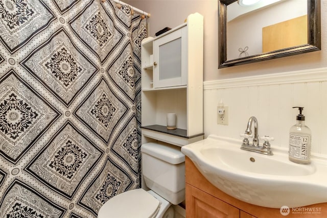 10510 66th Ave E, Puyallup, WA 98373 - full bath with vanity, a wainscoted wall, and a shower with shower curtain
