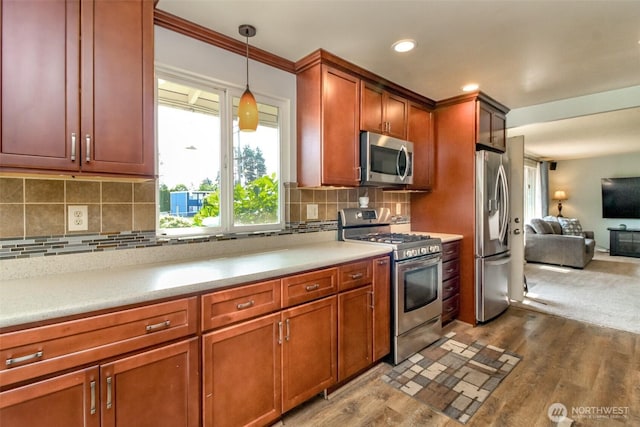 10510 66th Ave E, Puyallup, WA 98373 - kitchen featuring appliances with stainless steel finishes, dark wood finished floors, light countertops, hanging light fixtures, and recessed lighting