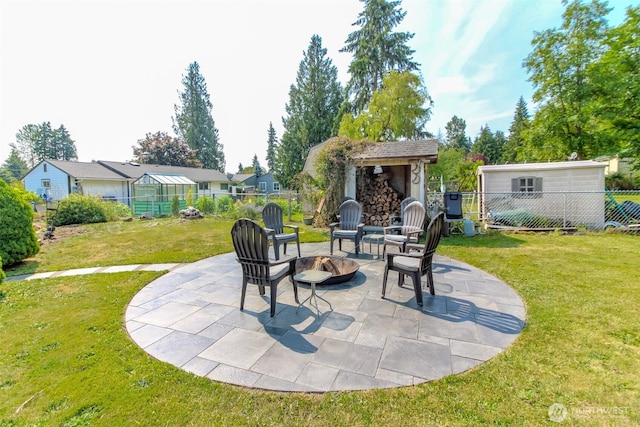 10510 66th Ave E, Puyallup, WA 98373 - fenced backyard with a fire pit, a patio, an outdoor structure, and a greenhouse