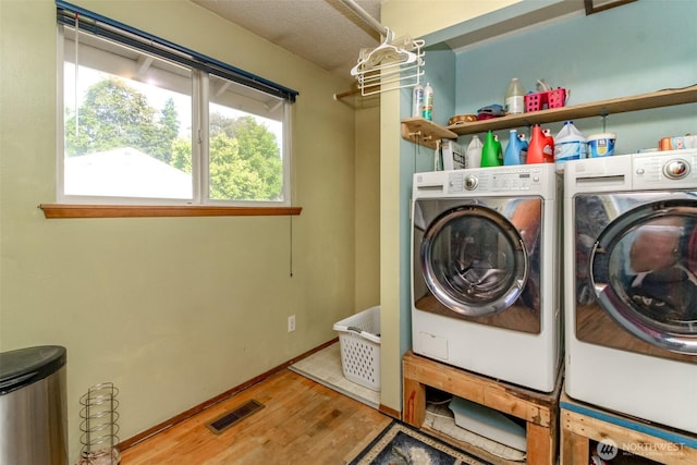 10510 66th Ave E, Puyallup, WA 98373 - washroom featuring separate washer and dryer and wood finished floors