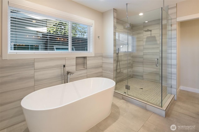 11838 79th Ave S, Seattle, WA 98178 - full bathroom featuring healthy amount of natural light, a shower stall, a freestanding tub, tile patterned floors, and tile walls