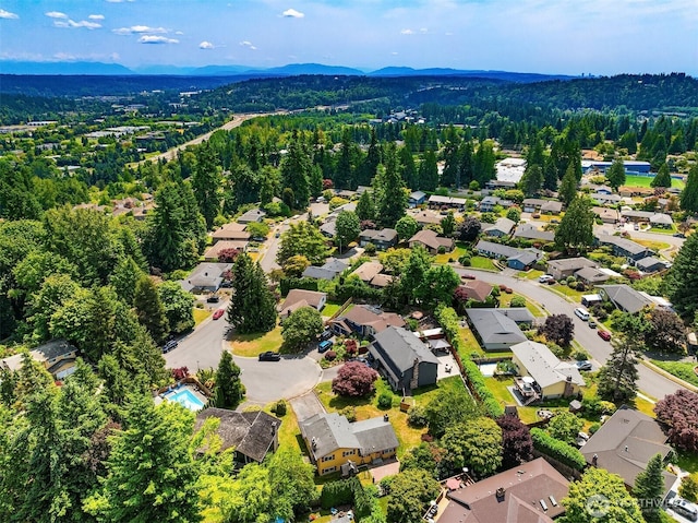10704 NE 200th Pl, Bothell, WA 98011 - aerial perspective of suburban area with a heavily wooded area and mountains