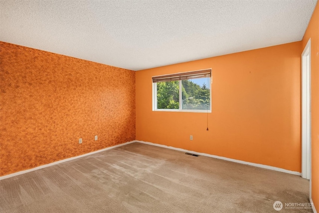 10704 NE 200th Pl, Bothell, WA 98011 - empty room with an accent wall, a textured ceiling, and carpet floors