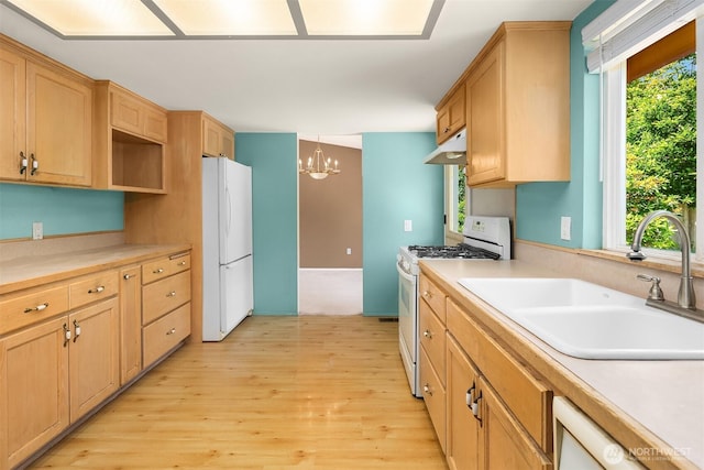 10704 NE 200th Pl, Bothell, WA 98011 - kitchen with white appliances, a chandelier, light wood-style floors, light countertops, and under cabinet range hood