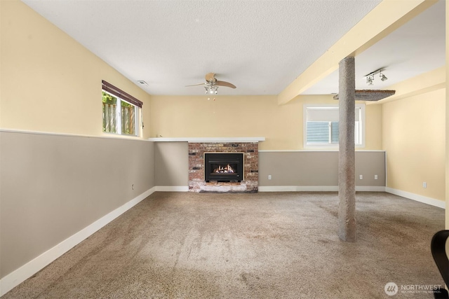 10704 NE 200th Pl, Bothell, WA 98011 - unfurnished living room featuring carpet flooring, ceiling fan, a brick fireplace, and a textured ceiling