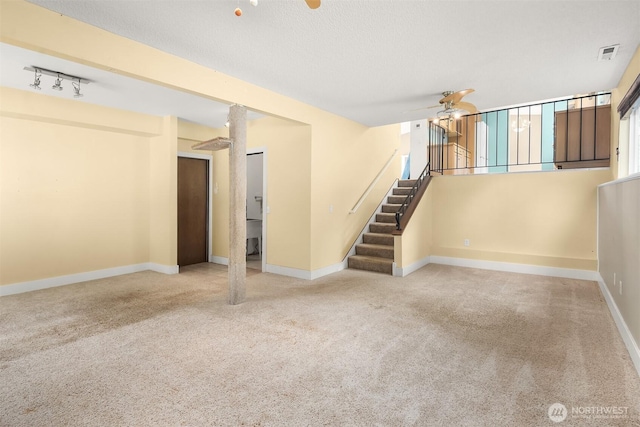 10704 NE 200th Pl, Bothell, WA 98011 - unfurnished living room featuring a ceiling fan, carpet, stairs, and a textured ceiling