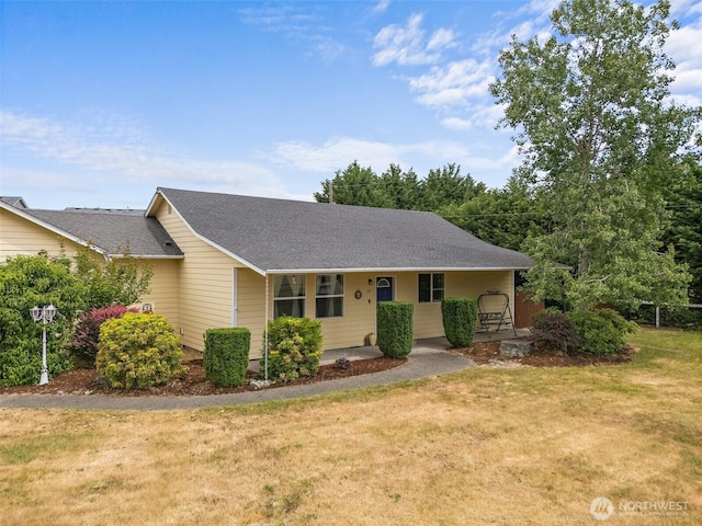 1815 181st St E, Spanaway, WA 98387 - view of front of property featuring covered porch, a front yard, and a shingled roof