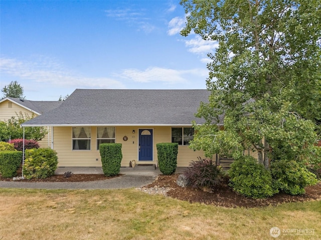 1815 181st St E, Spanaway, WA 98387 - view of front of house with a front yard and roof with shingles
