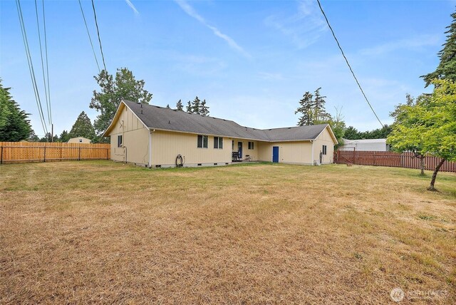 1815 181st St E, Spanaway, WA 98387 - back of property featuring a fenced backyard and crawl space