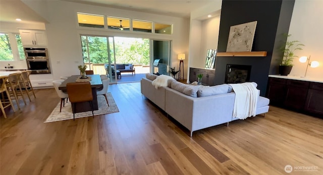 15 Sudden Valley Dr, Bellingham, WA 98229 - living room featuring light wood finished floors, a glass covered fireplace, and recessed lighting