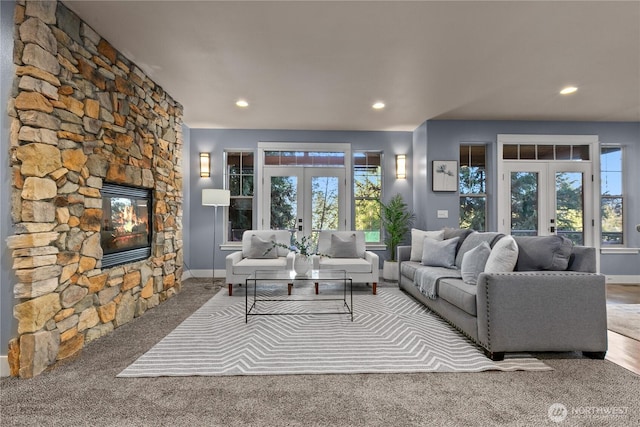 1 Valley View Cir, Bellingham, WA 98229 - living room featuring french doors, healthy amount of natural light, a stone fireplace, recessed lighting, and carpet floors