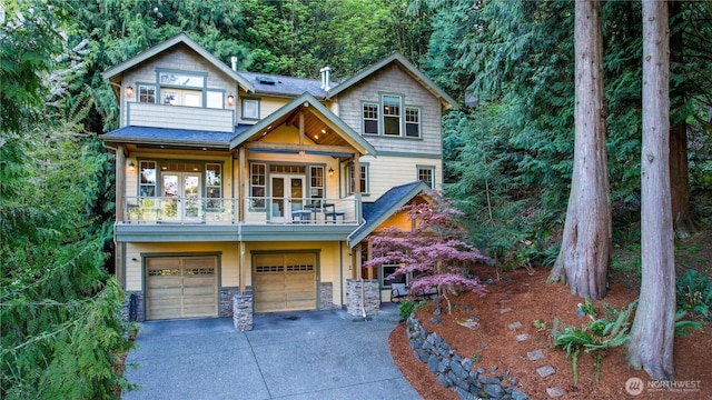 1 Valley View Cir, Bellingham, WA 98229 - craftsman house featuring a balcony, a garage, driveway, stone siding, and french doors