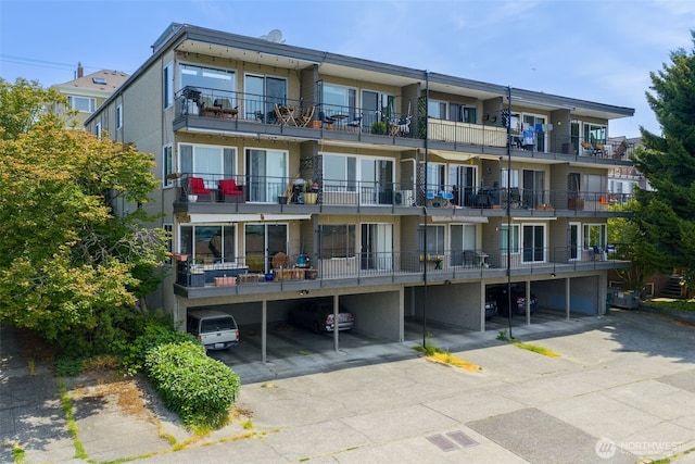 303 N 44th St Unit 105, Seattle, WA 98103 - view of apartment building / complex featuring covered parking