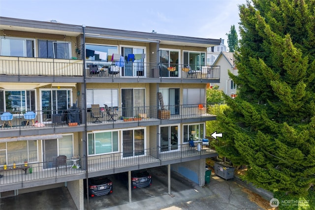 303 N 44th St Unit 105, Seattle, WA 98103 - view of property featuring covered parking