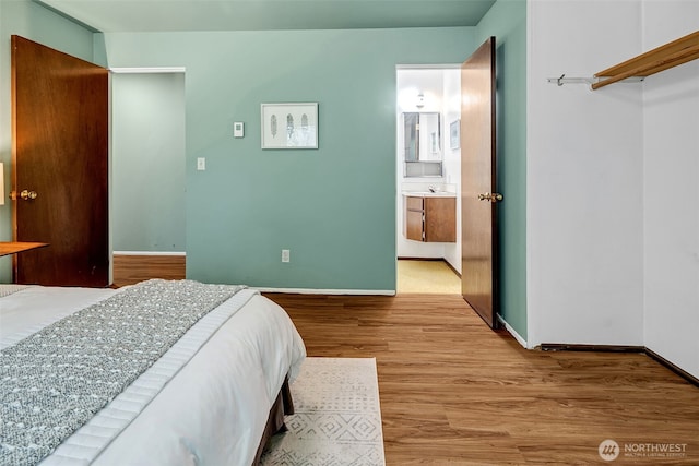 303 N 44th St Unit 105, Seattle, WA 98103 - bedroom featuring wood finished floors and baseboards