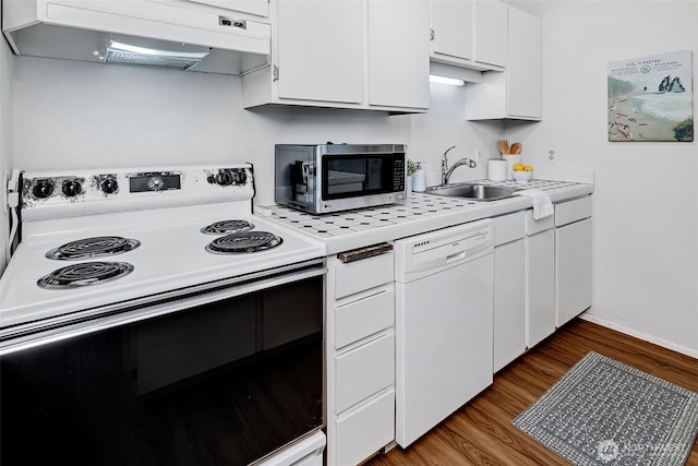 303 N 44th St Unit 105, Seattle, WA 98103 - kitchen with electric range oven, stainless steel microwave, dishwasher, custom range hood, and white cabinetry
