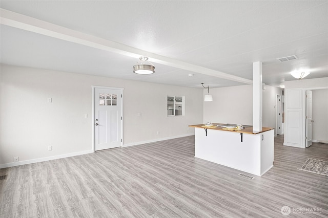3702 Hunt St Unit 21, Gig Harbor, WA 98335 - kitchen featuring light wood-style floors, open floor plan, and a breakfast bar area