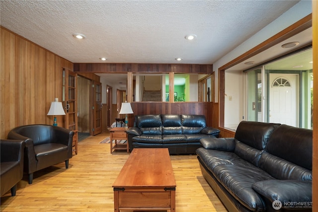 3701N Whitman St, Tacoma, WA 98407 - living room featuring wooden walls, light wood-style flooring, a textured ceiling, and recessed lighting