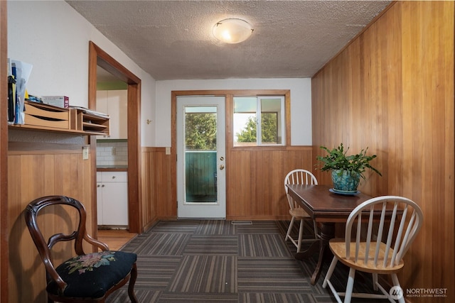 3701N Whitman St, Tacoma, WA 98407 - doorway to outside featuring a textured ceiling, wood walls, and wainscoting