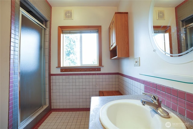 3701N Whitman St, Tacoma, WA 98407 - bathroom featuring tile walls, a stall shower, a wainscoted wall, tile patterned flooring, and vanity