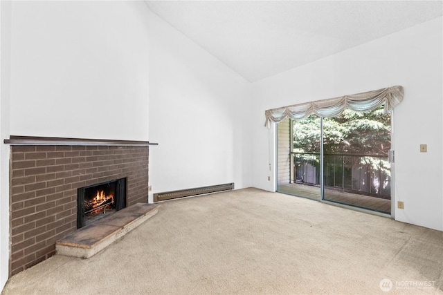 17529 151st Ave SE Unit 7-11, Renton, WA 98058 - unfurnished living room featuring a baseboard radiator, carpet, a brick fireplace, and high vaulted ceiling