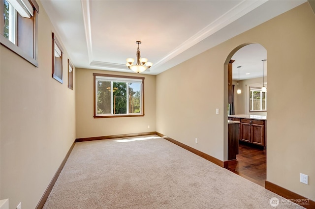 5728 SE 159th Ave, Snohomish, WA 98290 - spare room with arched walkways, dark carpet, a chandelier, and a tray ceiling
