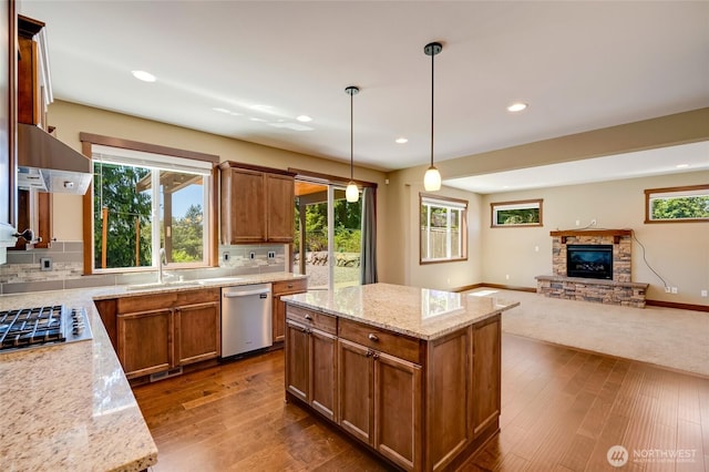 5728 SE 159th Ave, Snohomish, WA 98290 - kitchen with appliances with stainless steel finishes, extractor fan, dark wood-type flooring, a stone fireplace, and open floor plan