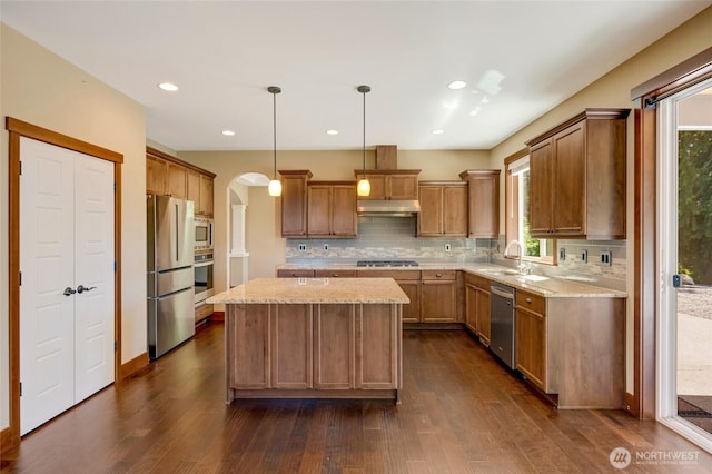 5728 SE 159th Ave, Snohomish, WA 98290 - kitchen featuring under cabinet range hood, stainless steel appliances, a center island, tasteful backsplash, and recessed lighting