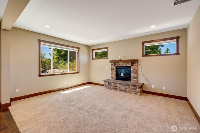 5728 SE 159th Ave, Snohomish, WA 98290 - unfurnished living room featuring a stone fireplace, carpet flooring, and recessed lighting