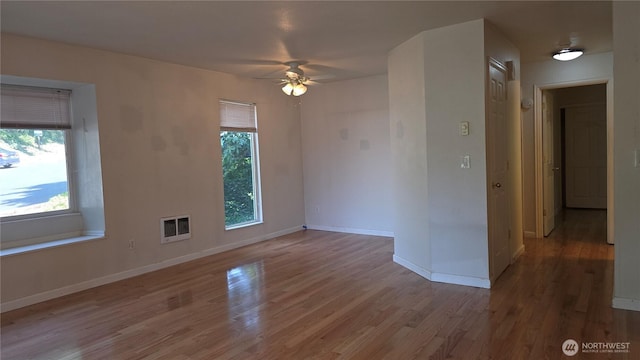 1040 Columbia River Dr Unit 1, Vancouver, WA 98664 - unfurnished room with a ceiling fan, wood finished floors, and heating unit
