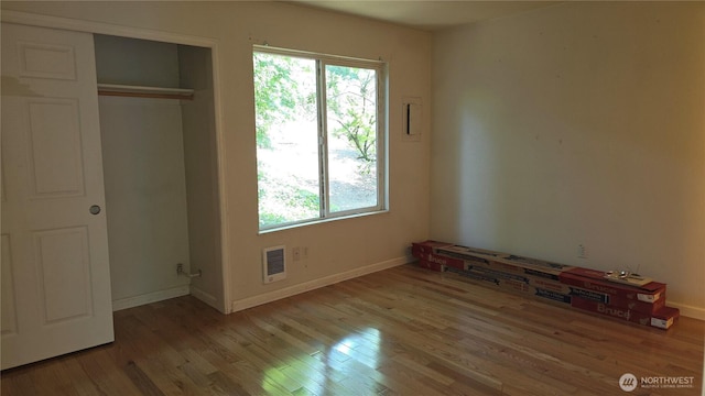1040 Columbia River Dr Unit 1, Vancouver, WA 98664 - unfurnished bedroom with multiple windows, wood finished floors, and a closet