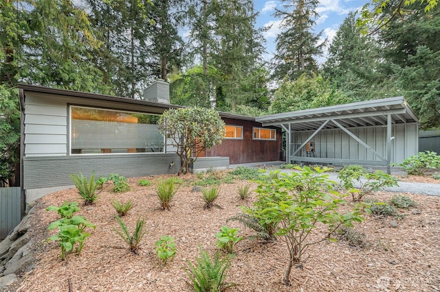 2329 NE 103rd St, Seattle, WA 98125 - back of house with a chimney and board and batten siding