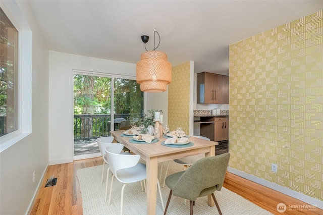 2329 NE 103rd St, Seattle, WA 98125 - dining space featuring light wood finished floors and wallpapered walls