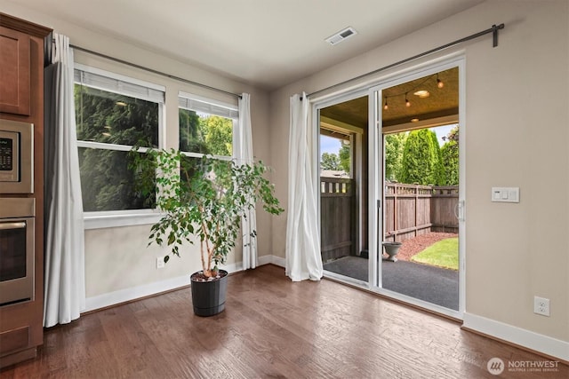 8910 Buttercup St SE, Tumwater, WA 98501 - doorway with dark wood-style floors and baseboards