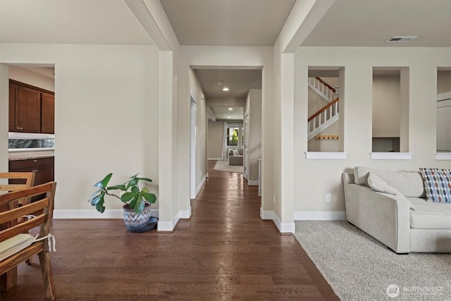 8910 Buttercup St SE, Tumwater, WA 98501 - hall featuring dark wood-style floors and stairs