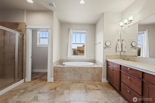 8910 Buttercup St SE, Tumwater, WA 98501 - bathroom with vanity, a shower stall, a garden tub, and recessed lighting